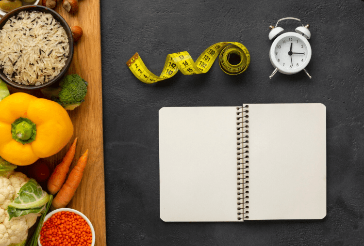 Healthy foods, notebook, clock, measuring tape